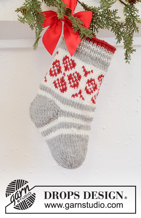 Christmas Flower Stocking / DROPS Extra 0-1573 - Knitted Christmas stocking in DROPS Snow. The piece is worked top down, with stripes and Nordic pattern. Theme: Christmas.