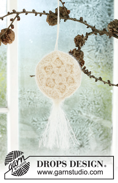 Frozen Flowers / DROPS Extra 0-1589 - Crocheted Christmas ball in DROPS BabyMerino and DROPS Kid-Silk. Piece is crocheted in 2 parts in the round from the center and outwards, with relief pattern, start and tassel. Theme: Christmas.