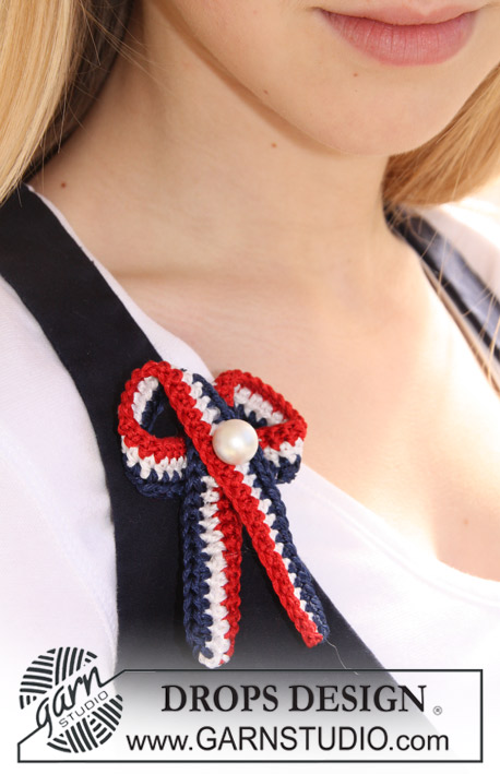May Colours / DROPS Extra 0-670 - Spilla nastro per la Festa Nazionale Norvegese DROPS all’uncinetto, in Cotton Viscose con perla.