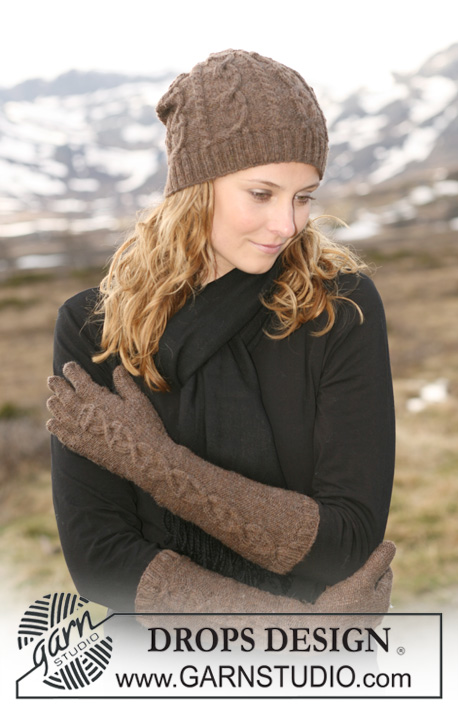 Lola / DROPS 114-34 - Set comprises: Knitted DROPS hat and gloves with cables in ”Fabel” or Flora.