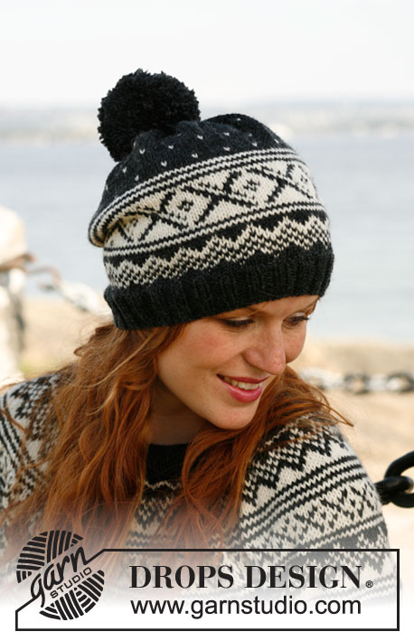 Nordic Night / DROPS 131-13 - Knitted DROPS hat with Norwegian pattern and large pompom in ”Karisma”. 