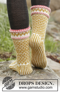 Hokey Pokey / DROPS 173-42 - Set consists of: Knitted DROPS mittens and toe-up socks with Nordic pattern, Latvian braid and pompoms in ”Karisma”.