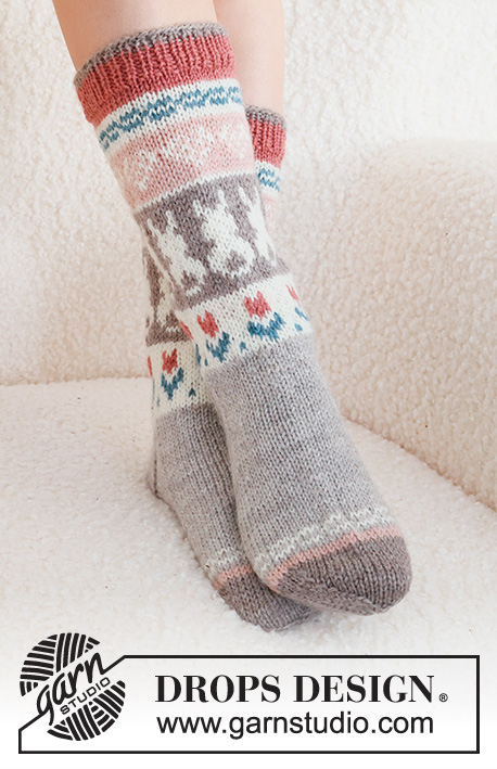Dancing Bunny Socks / DROPS 229-34 - Knitted socks in DROPS Karisma. The piece is worked top down in stockinette stitch, with multi-colored pattern and heart, Easter bunny and flower. Sizes 35 – 46 = US 4 1/2 - 12 1/2. Theme: Easter.
