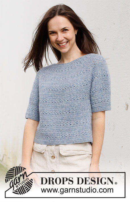 Spring Renaissance Top / DROPS 230-40 - Crocheted sweater with short sleeves / t-shirt in DROPS Sky. Piece is crocheted top down with round yoke and lace pattern. Size: S - XXXL