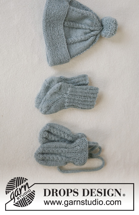 Lille Trille / DROPS Baby 14-2 - Gestrickte Jacke mit Rundpasse und Zopfmuster, Mütze mit Pompons, Handschuhe und Socken in DROPS Alpaca für Babys und Kinder. Größe 1 Monat - 3 Jahre.