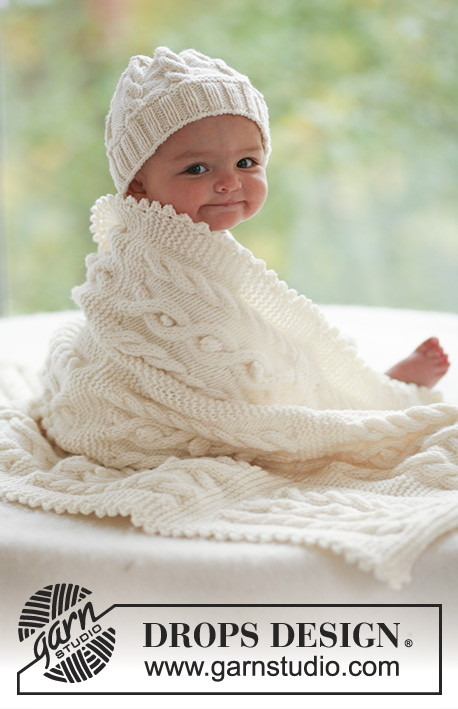 Cables and Cuddles / DROPS Baby 17-28 - Souprava: dětská čepice a deka s copánkovým vzorem pletené z příze DROPS Merino Extra Fine. Motiv: Dětské deky.