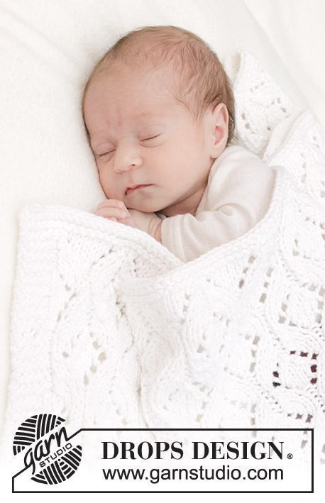 Bright Cuddles Blanket / DROPS Baby 46-4 - Manta de punto para bebé en DROPS Big Merino. La labor está realizada con patrón de calados.