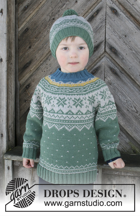 Seiland Jumper / DROPS Children 30-5 - Komplet składa się ze: swetra dziecięcego z zaokrąglonym karczkiem i żakardem norweskim, przerabianego od góry do dołu. Czapki z żakardem norweskim i pomponem. Od 2 do 12 lat. 
Z włóczki DROPS Merino Extra Fine.