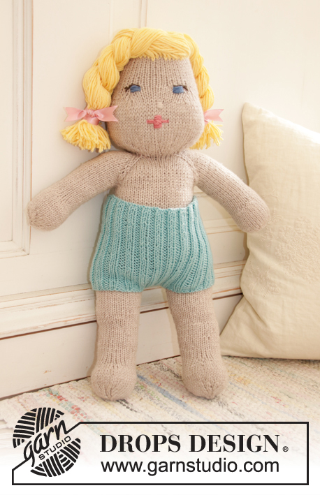 Cora / DROPS Children 35-12 - Knitted doll with short pants and tube socks. The doll is worked top down in stocking stitch with 2 strands DROPS BabyMerino or 1 strand  DROPS Big Merino, and DROPS Cotton Merino. Short pants and tube socks are worked in rib with 1 strand DROPS BabyMerino.