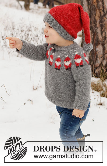 Merry Santas / DROPS Children 41-1 - Pull de Noël et bonnet enfant tricotés en DROPS Air. Le pull se tricote de haut en bas avec empiècement arrondi et jacquard Père Noël. Le bonnet tricote en rond, de bas en haut. Du 2 au 14 ans. Thème: Noël.