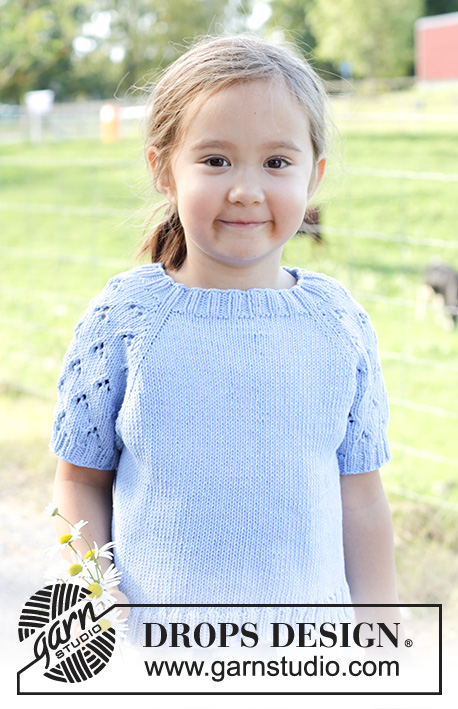 Daisy Fields Top / DROPS Children 48-3 - Knitted short-sleeved jumper/ top, for children in DROPS Cotton Light. The piece is worked top down with raglan and lace pattern on sleeves. Sizes 2 – 12 years.